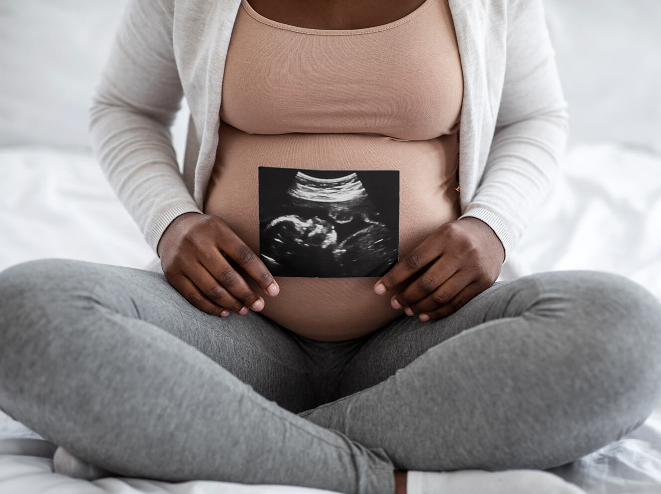 African American pregnant woman with ultrasound picture