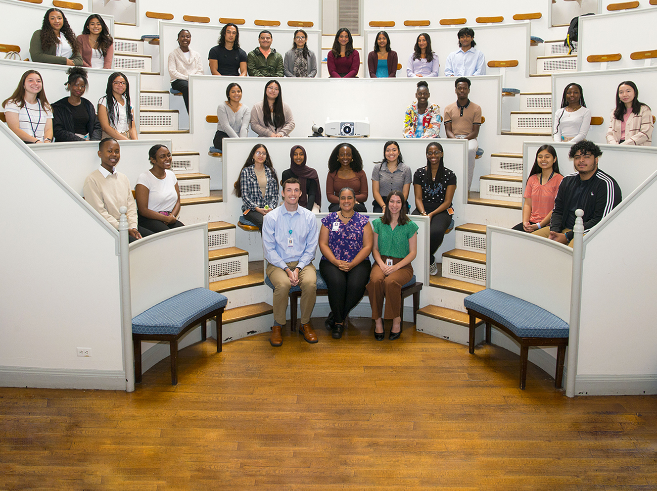 Pictured in Mass General's historic Ether Dome are 2023 high school and undergraduate interns of the Youth Neurology Education and Research Program, along with program staff and director Nicte Mejia, MD, MPH, FAAN (front center).